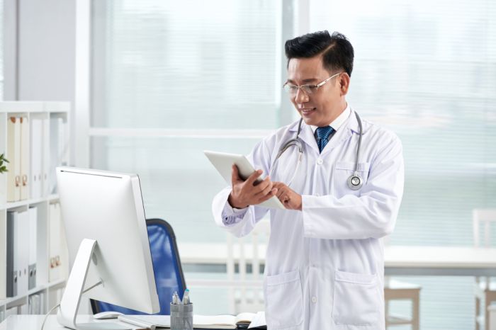 asian-doctor-using-medical-app-his-digital-device-1