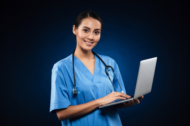 cheerful-lady-medical-uniform-using-laptop_171337-4286