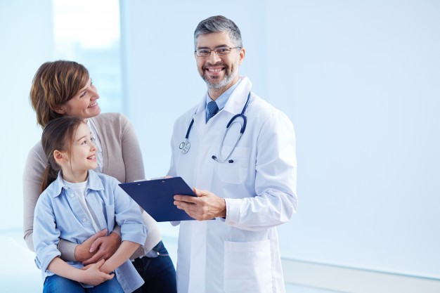 happy-doctor-holding-clipboard-with-patients_1098-2176